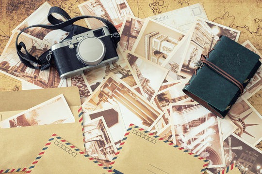 Holiday memories.  Old postcards with a map, photo camera and travel notebook
