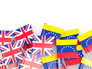 Pins with flags of UK and venezuela isolated on white.