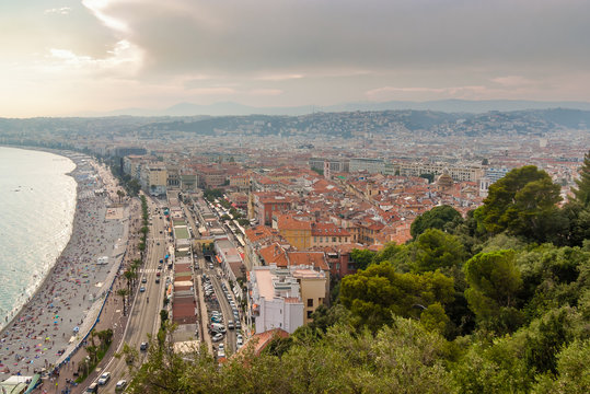 During sunset beautiful panoramic top view of the city of Nice, France. View of Promenade des Anglais in Nice with apartment houses and beach bordering the Mediterranean Sea.