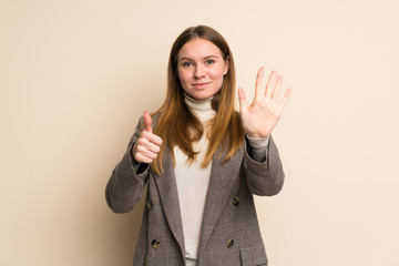 Young business woman counting six with fingers