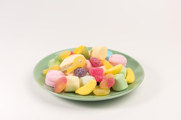 Plate with sweets isolated on a white background. Marmalade and marshmallow.
