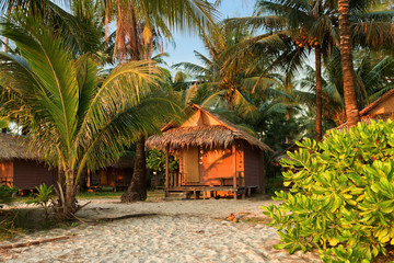 Cheap bungalows for backpackers on a tropical beach in evening time. Thailand