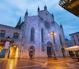 Como - The portal of Duomo at dusk.