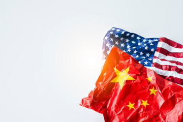 Wrinkle of USA and China flag on sky background. It is symbol of United states of America and China...