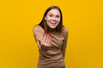Young woman over colorful background inviting to come