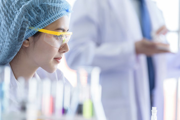 Asian young girl student scientist researching  and learning in a laboratory.