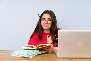 Frustrated Teenager student girl studying in a table