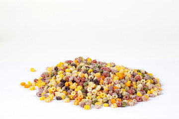 Colourful star shaped pasta macaroni vegetable on white background
