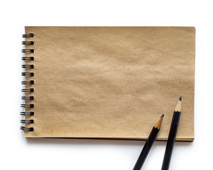 Blank notepad with pen and pencil on office wooden table