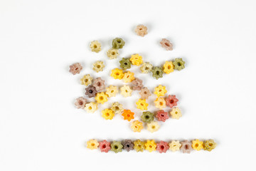 Colourful star shaped pasta macaroni vegetable on white background