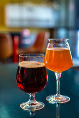 glasses of craft beer are on the table in the bar. lager and stout