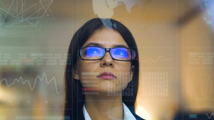 The beautiful businesswoman in glasses on the hologram background - Powered by Adobe