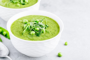 Summer cream soup with green fresh pea shoots
