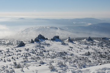 Fototapeta na wymiar Snowy cliffs and a ski resort on a bright sunny morning