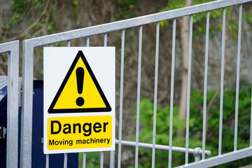 Moving machinery danger yellow sign