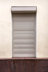 Window with roller shutters on white background