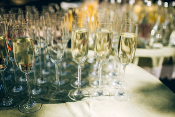 The waiter pours champagne to a party. glasses of champagne.
