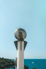 Round glass lanterns on the background of the sea coast. Shoreline lighting with energy-saving lamps