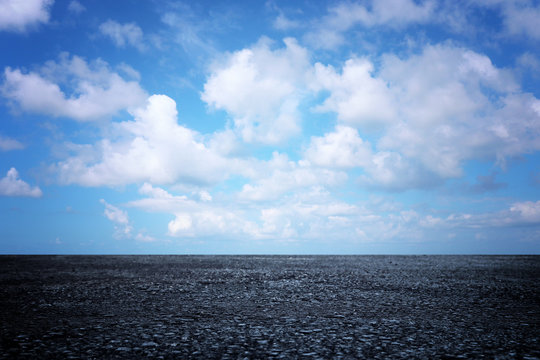 Background Image Of Asphalt Road And Clear Blue Sky With Clouds At Horizon