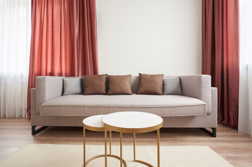 small living room with a sofa, armchair, coffee table and carpet