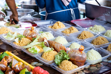 Vendor selling nasi tomato in street bazaar stall for iftar