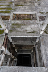 staircase in an unfinished building, abandoned, concrete floors, ruins, concrete elevator shaft