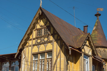 Fototapeta na wymiar Old German wooden yellow building. Upper part of the building.