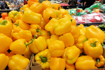 Yellow bell pepper in market, groceries, bulk produce