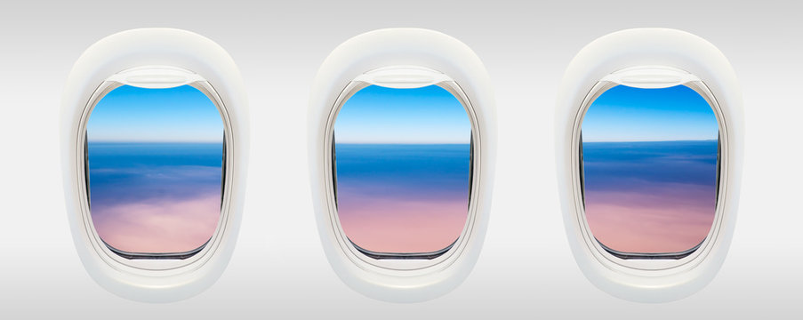 Windows of airplane from inside, blue sky and pink clouds, aerial travel concept