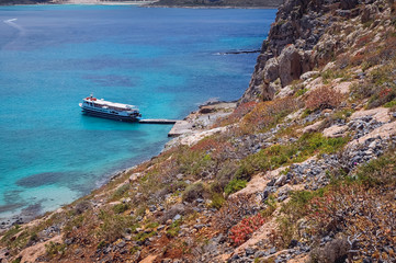 Tourist boat on a shore of Imeri Gramvousa Island near island of Crete, Greece