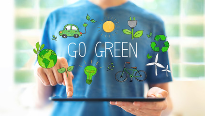 Go green with young man using a tablet computer