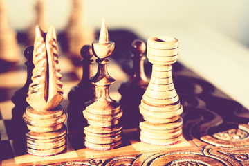 Wooden chess pieces on a chessboard, leadership concept on white background.
