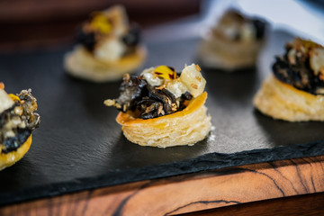 Escargots- Snails with herbs and spices on puff pastry. Gourmet delicacy appetizer