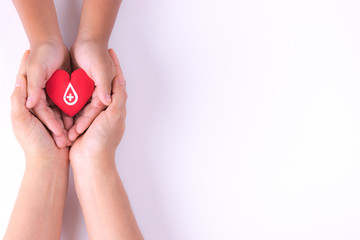 Woman and child hands holding red heart  for blood donation concept,World blood donor day, health care love, hope and family concept, world heart day,world health day. Copy space for advertisers. - obrazy, fototapety, plakaty