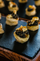 Escargots- Snails with herbs and spices on puff pastry. Gourmet delicacy appetizer