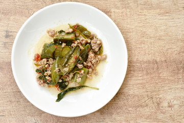 spicy stir fried slice eggplant with minced pork and basil leaf on plate