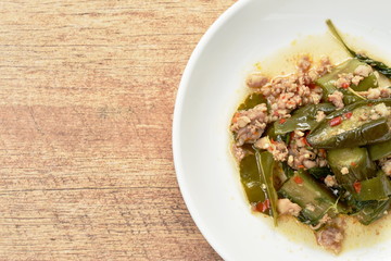 spicy stir fried slice eggplant with minced pork and basil leaf on plate