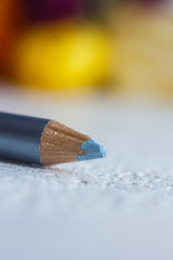 cosmetic pencil for applying makeup on the face close-up. eye liner in macro on blurred background