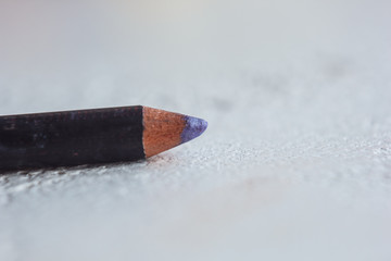 cosmetic pencil for applying makeup on the face close-up. eye liner in macro on blurred background