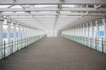 Obraz premium Rhythm of Empty Pedestrian Glass Tunnel