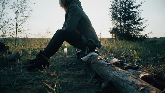 Girl Sitting in Front of Fire. Slow motion footage.