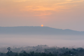Fototapeta premium The rising sun, sky cloud sunrise abstract with mountain, background and fog