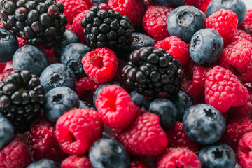 Fresh Summer Berries mix Background with Strawberry, Raspberry, Red currant, Blueberry and Blackberry.