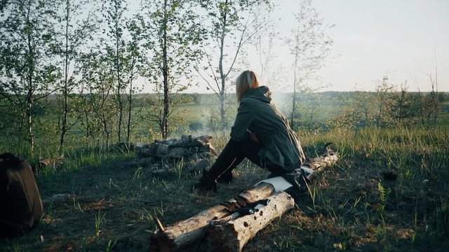 Girl Sitting in Front of Fire. Slow motion footage.