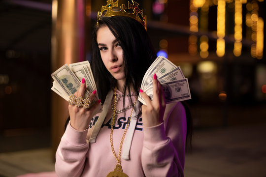 Rich bitch in crown play with dollars money at night city like queen