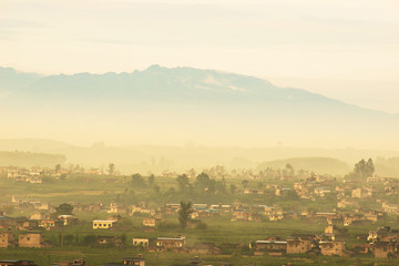 Misty peaks and villages in the morning, in southwestern China.