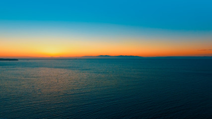 Seascape with orange sunset over the horizon.