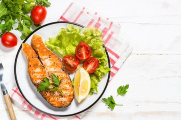 Grilled salmon fish steak on white.