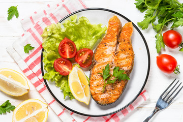 Grilled salmon fish steak on white.