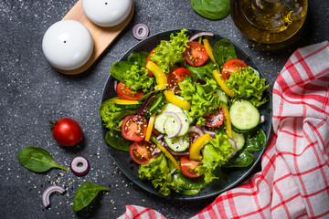 Fresh vegetables salad on black.